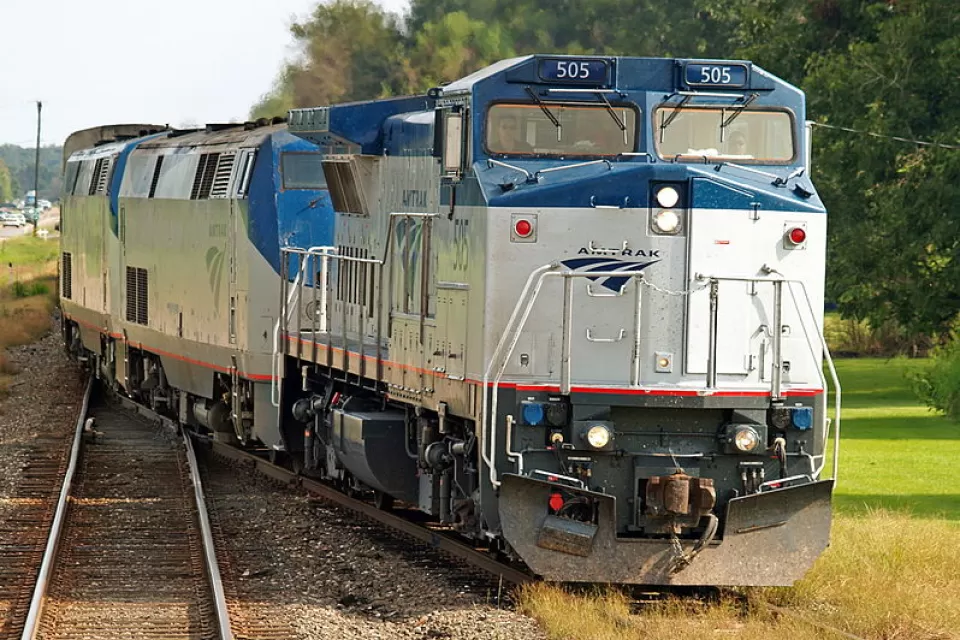 Amtrak Sunset Limited train passing by forested area in Cade, Louisiana